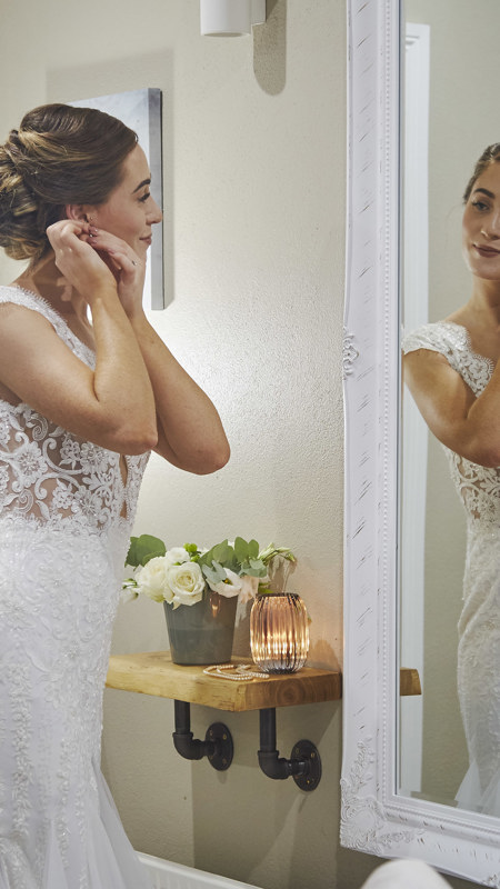 Bride getting ready in front of the mirror