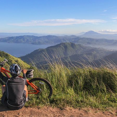 Cyclist enjoying view from the top of the mountain
